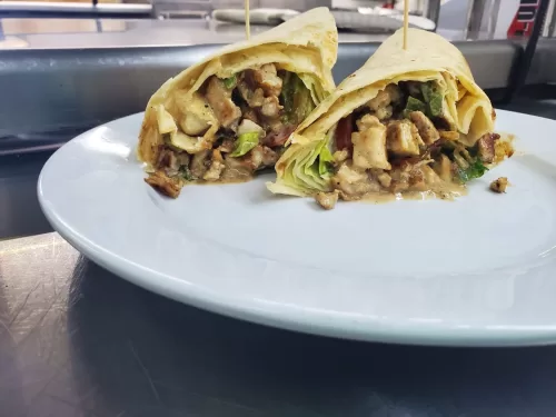 Philly Cheese Chicken Wrap with provolone, grilled chicken, lettuce, tomato