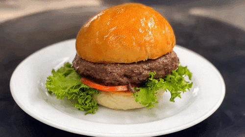 Hamburger on a fresh bun with lettuce tomato