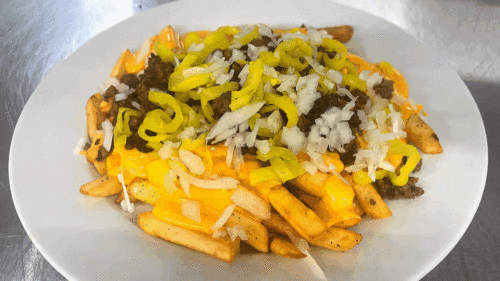 Nacho fries covered in nacho sauce, banana pepper, seasoned beef, onion.