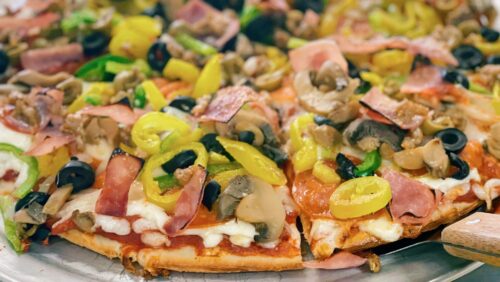 Works Pizza wit red sauce, pepperoni, onions, mushrooms, green and black olives, green and banana peppers, and hand pulled fresh sausage.