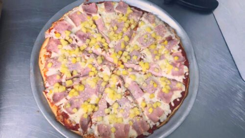 Hawaiian Pizza with cheese, ham, and pineapple